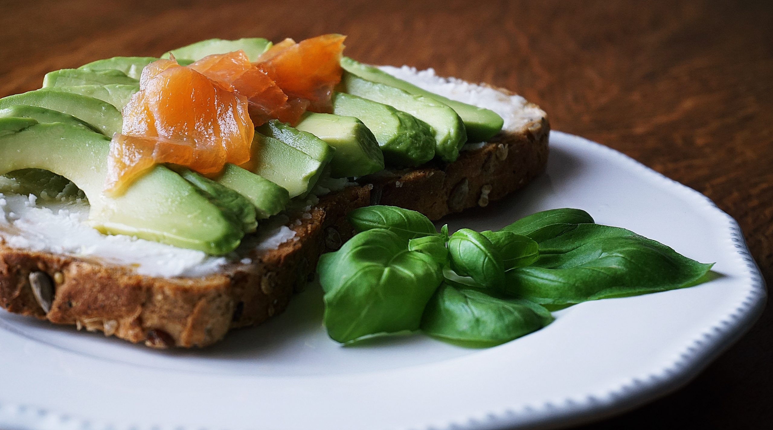 bread with sliced avocado and salmon near basil mint on 2072867 scaled